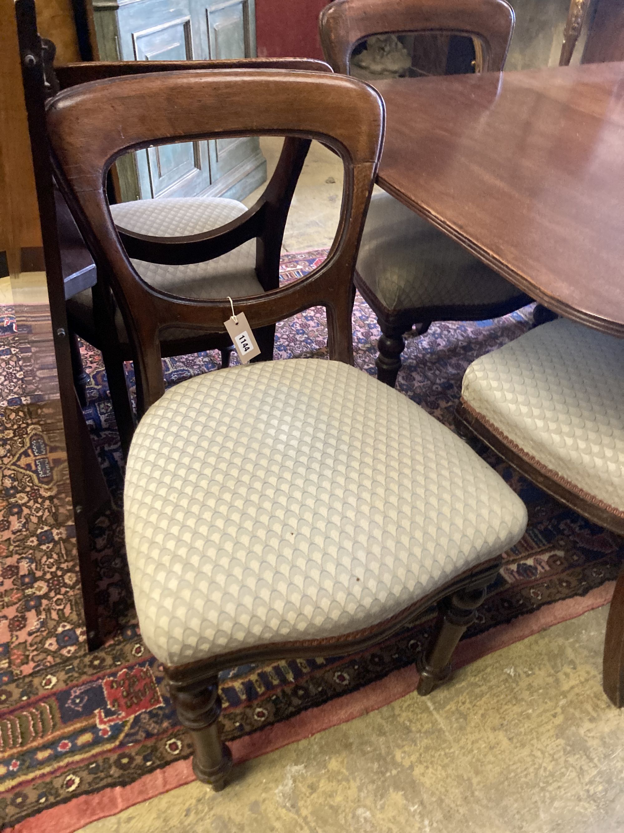 A George III style mahogany twin pillar extending dining table, extended 270cm (one spare leaf), together with a set of six Victorian o